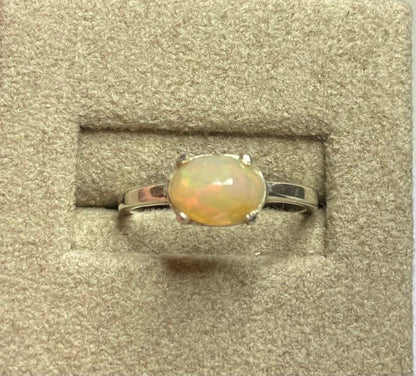 Oval faceted Ethiopian Wello opal band ring in sterling silver.