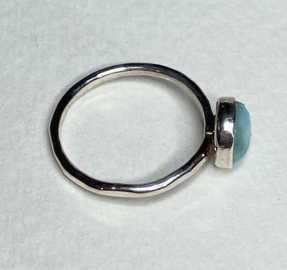 Sterling silver band ring with a bezel-set larimar cabochon.