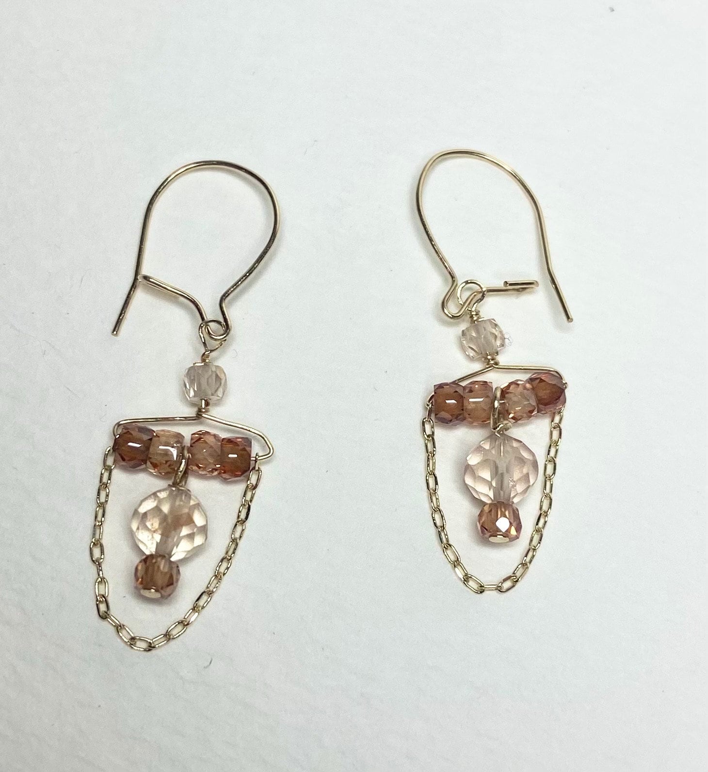 Dangle drop earrings with Oregon sunstones and zircons on gold chains.