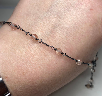 A delicate sterling silver necklace with peach Oregon sunstone beads.