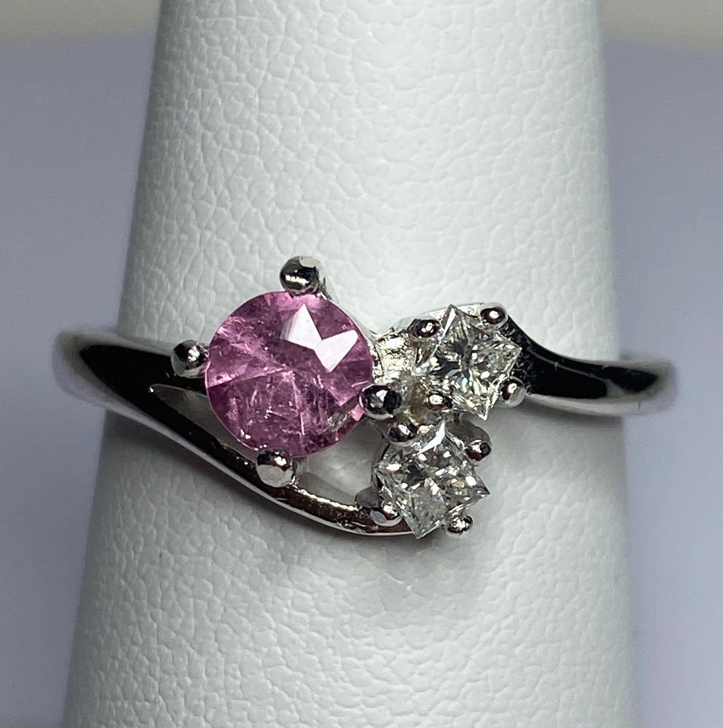 Sterling silver ring with a pink tourmaline and two diamonds.