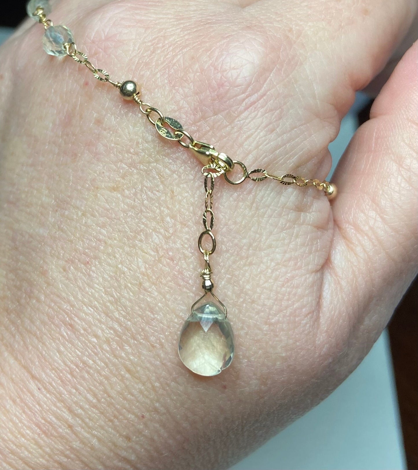 14k yellow gold choker necklace with light yellow beads and a faceted briolette pendant.