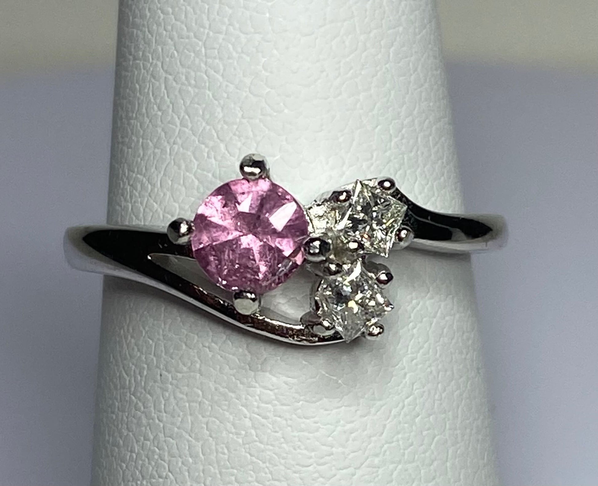 Sterling silver ring with a pink tourmaline and two diamonds.