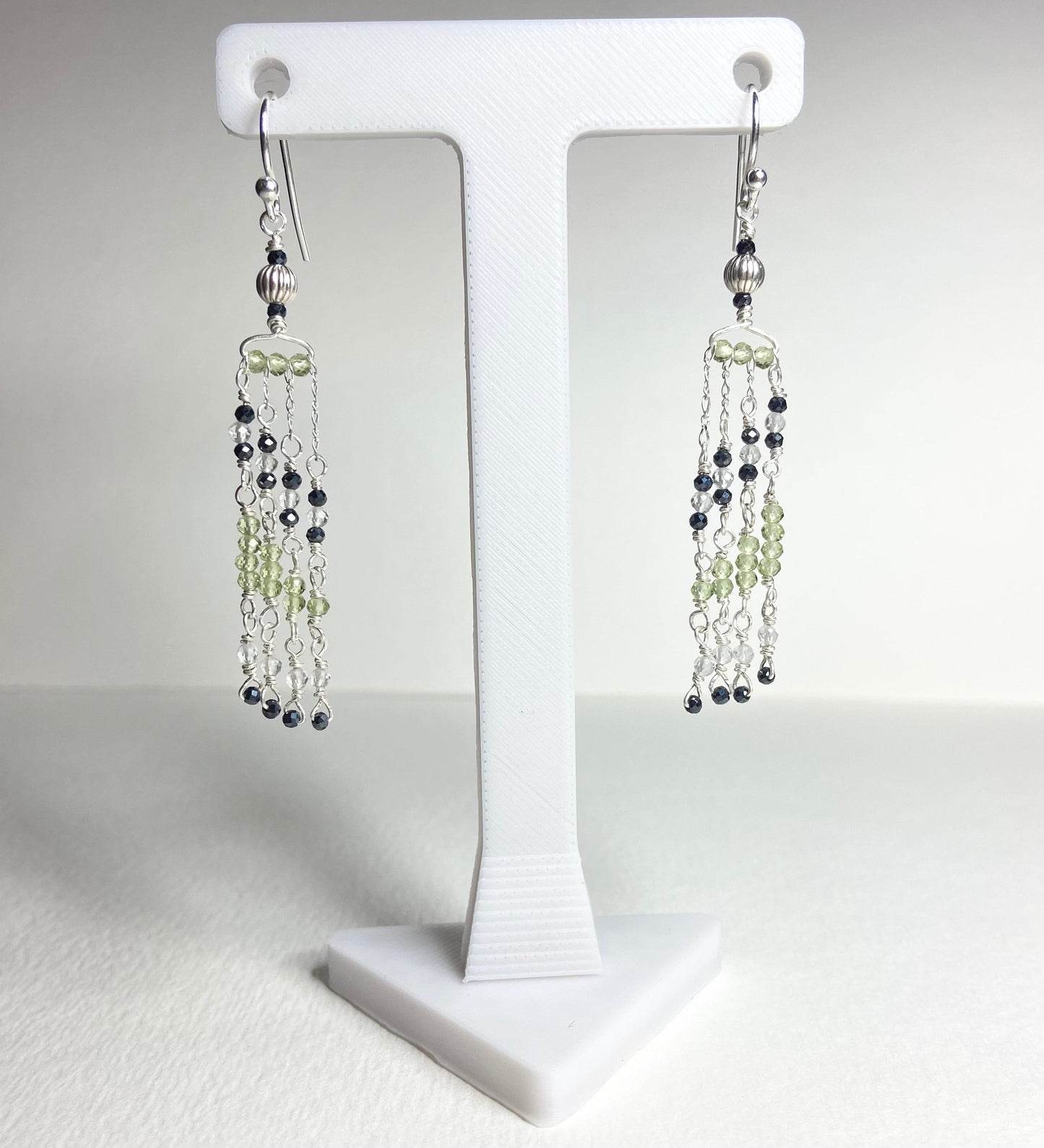 Sterling silver dangle earrings with black diamond and peridot beaded fringe.