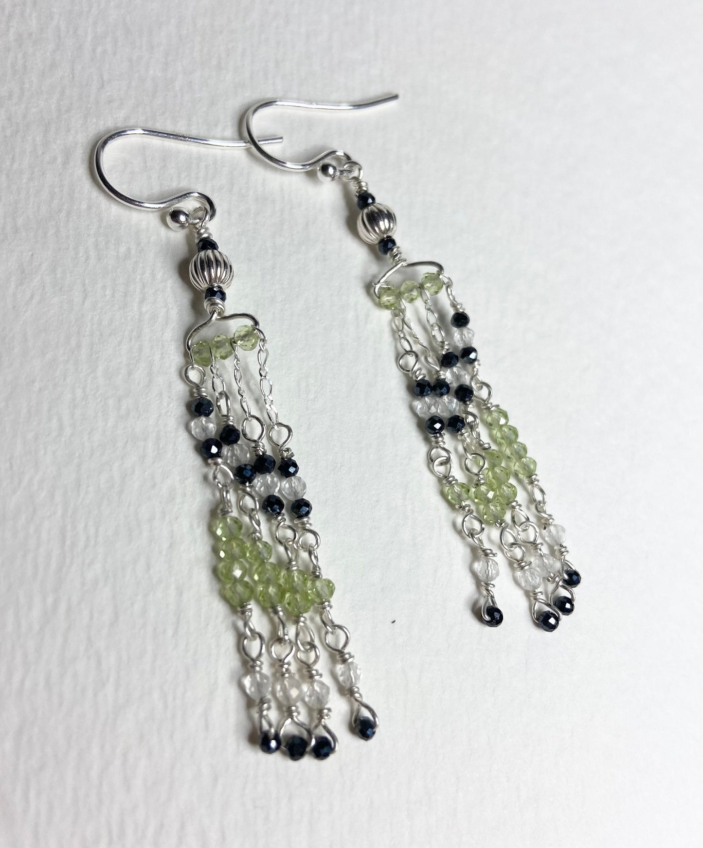 Sterling silver dangle earrings with black diamond and peridot beads.