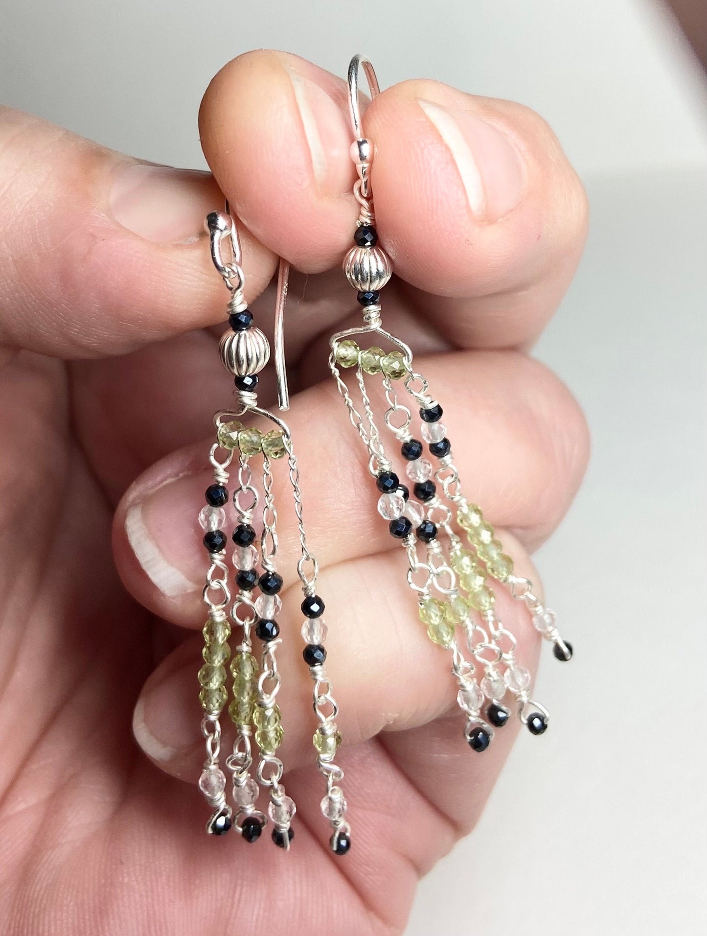 Sterling silver dangle earrings with black diamond and peridot beaded fringe.