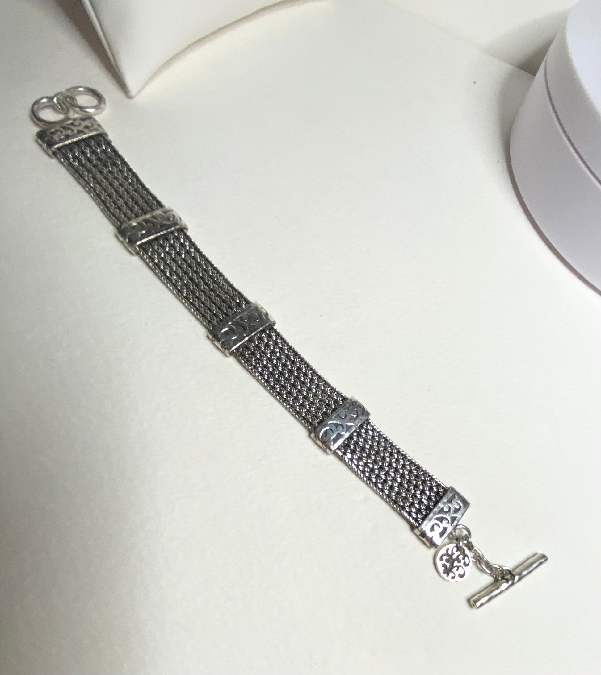 Lois Hill wide woven toggle sterling silver bracelet with charm.