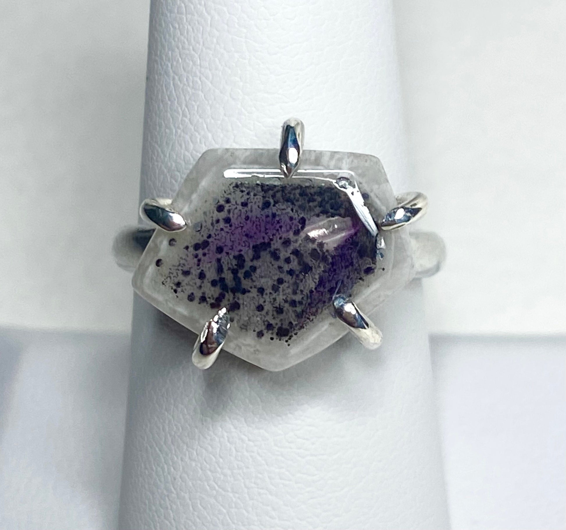 Sterling silver ring with a hexagonal quartz stone featuring amethyst inclusions.