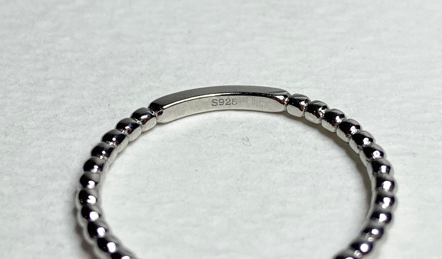 Sterling silver beaded band ring with "S925" stamp.