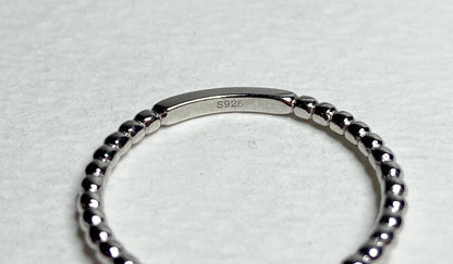 Sterling silver beaded band ring with "S925" stamp.