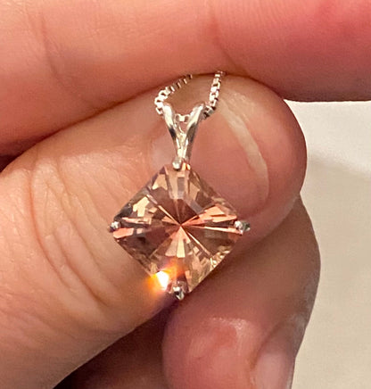 A large Oregon sunstone pendant with a fancy cut in sterling silver.
