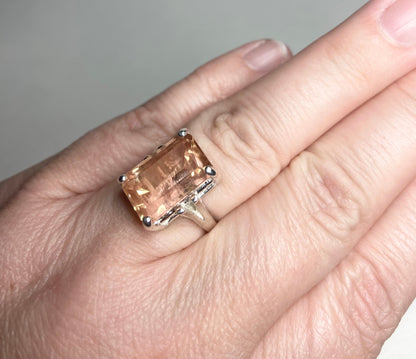 Sterling silver band ring with a large, emerald-cut Oregon sunstone.