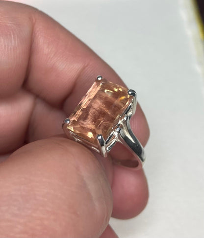 Sterling silver band ring with a large, emerald-cut Oregon sunstone.