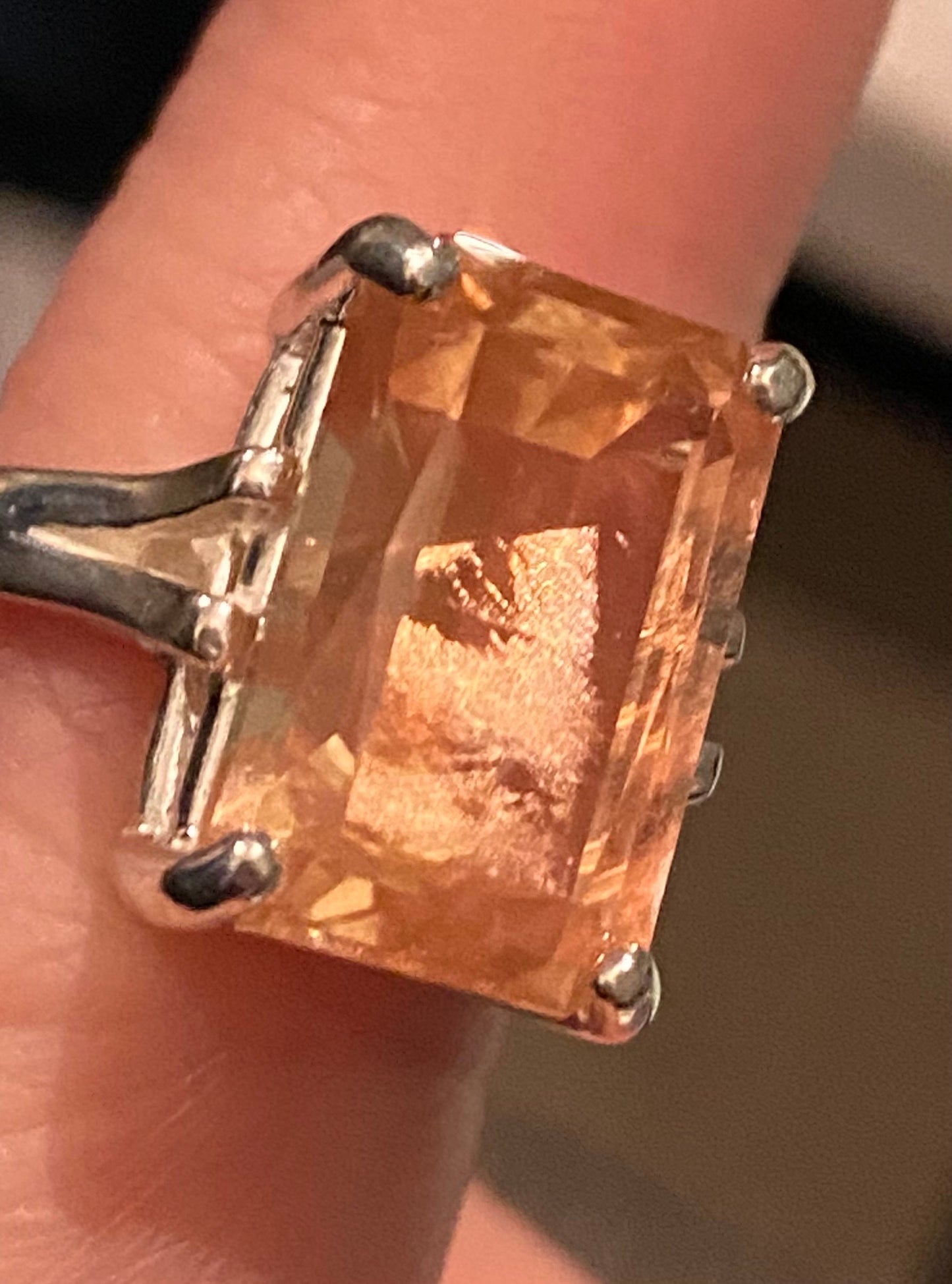 Sterling silver band ring featuring a large, emerald-cut Oregon sunstone with coppery schiller.