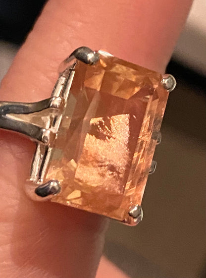 Sterling silver band ring featuring a large, emerald-cut Oregon sunstone with coppery schiller.