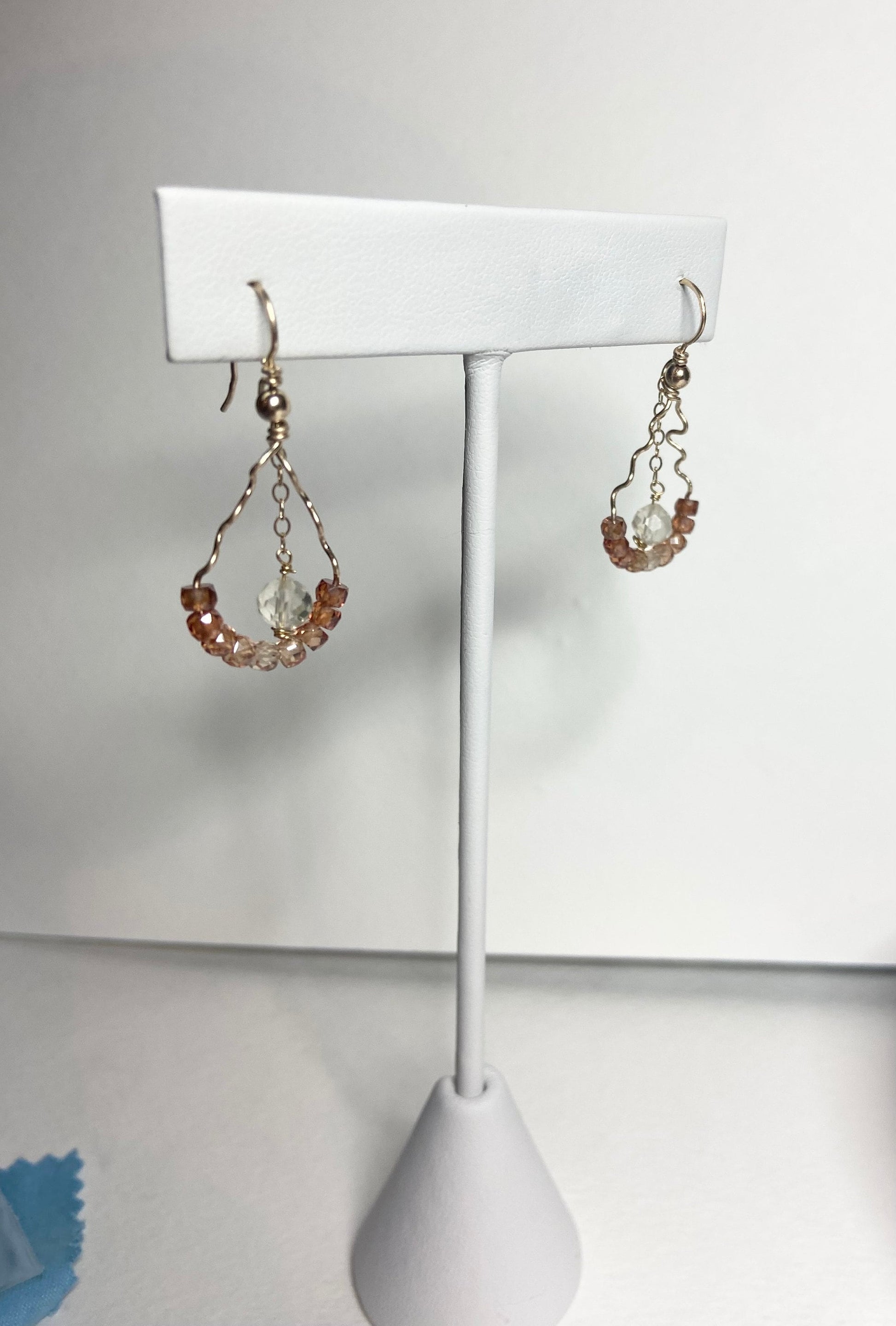 Hand-forged dangle earrings with natural zircons and an Oregon sunstone.