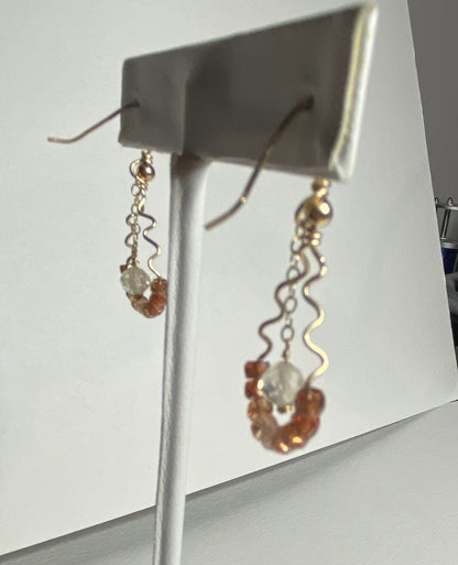 Hand forged dangle drop earrings with natural zircons and Oregon sunstone.