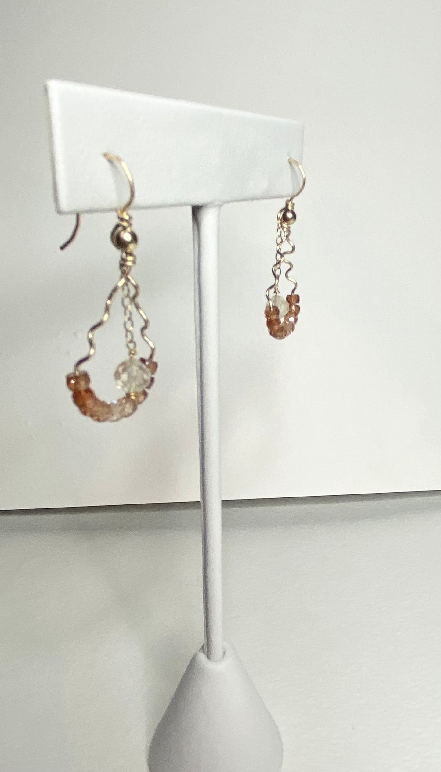 Hand-forged dangle earrings with natural zircons and an Oregon sunstone.