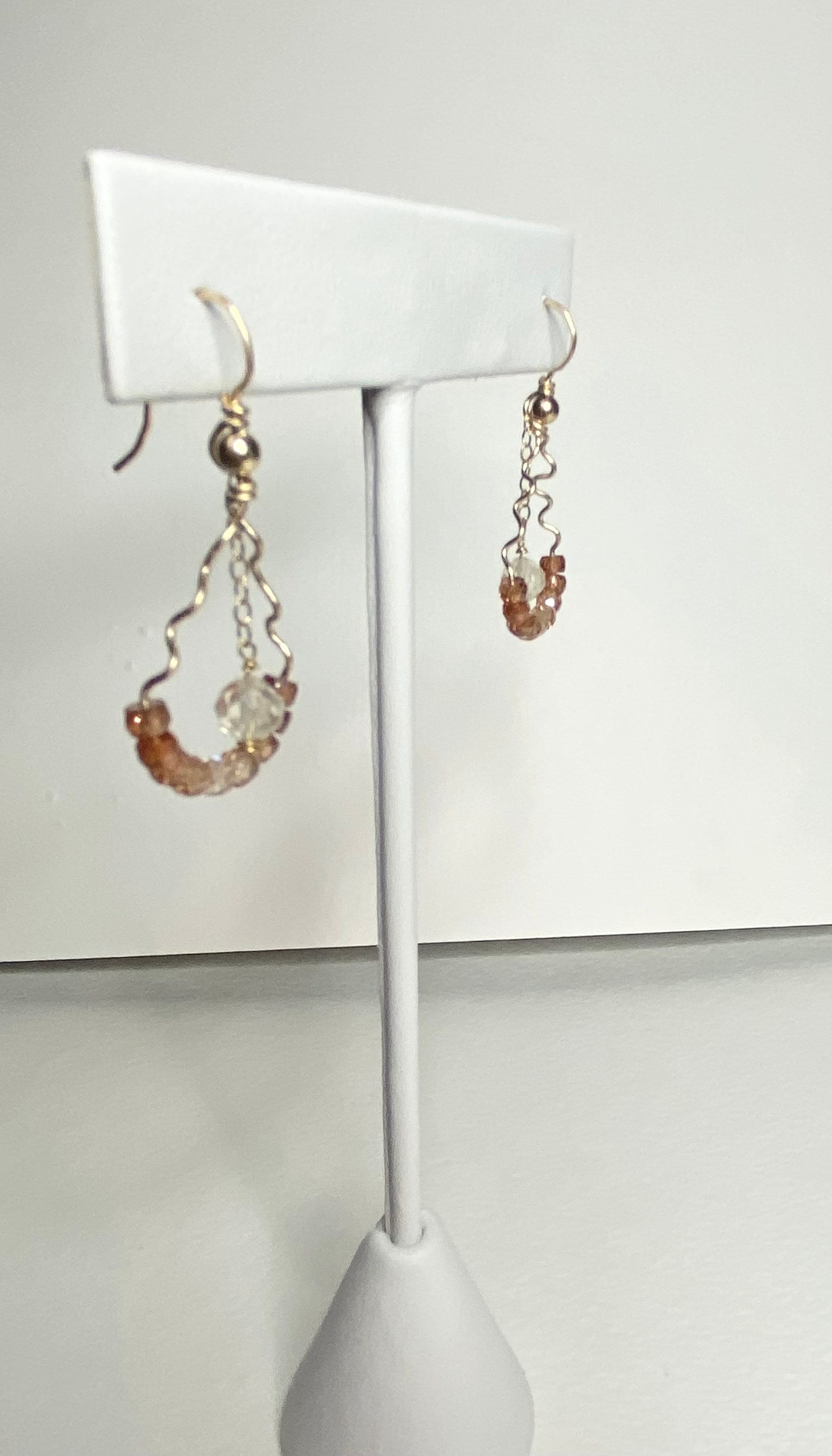 Hand-forged dangle earrings with natural zircons and an Oregon sunstone.