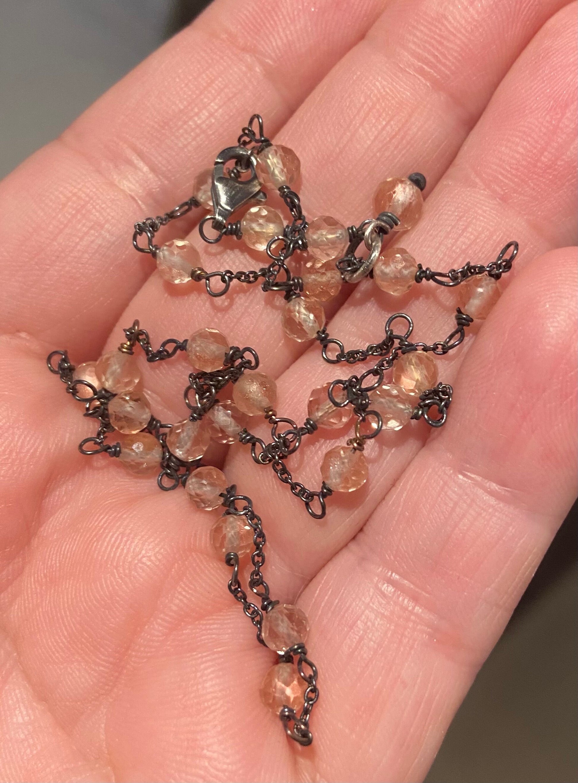 Adjustable sterling silver necklace with peach Oregon sunstone beads.