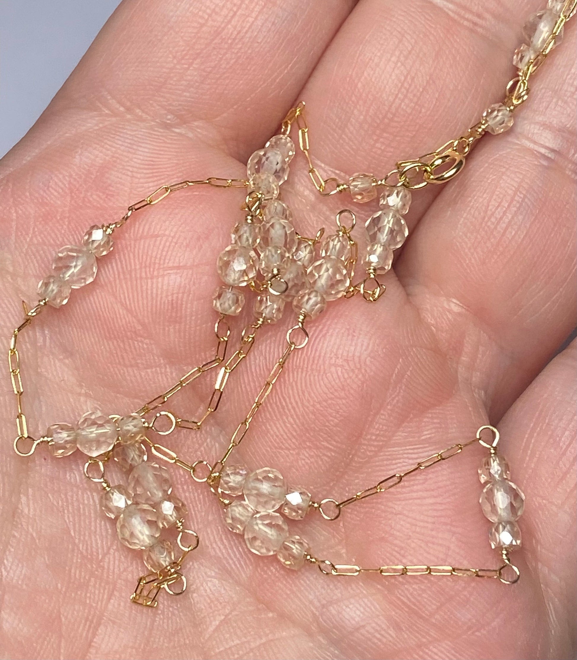 Solid 14k yellow gold necklace with faceted Oregon sunstones and natural zircons.