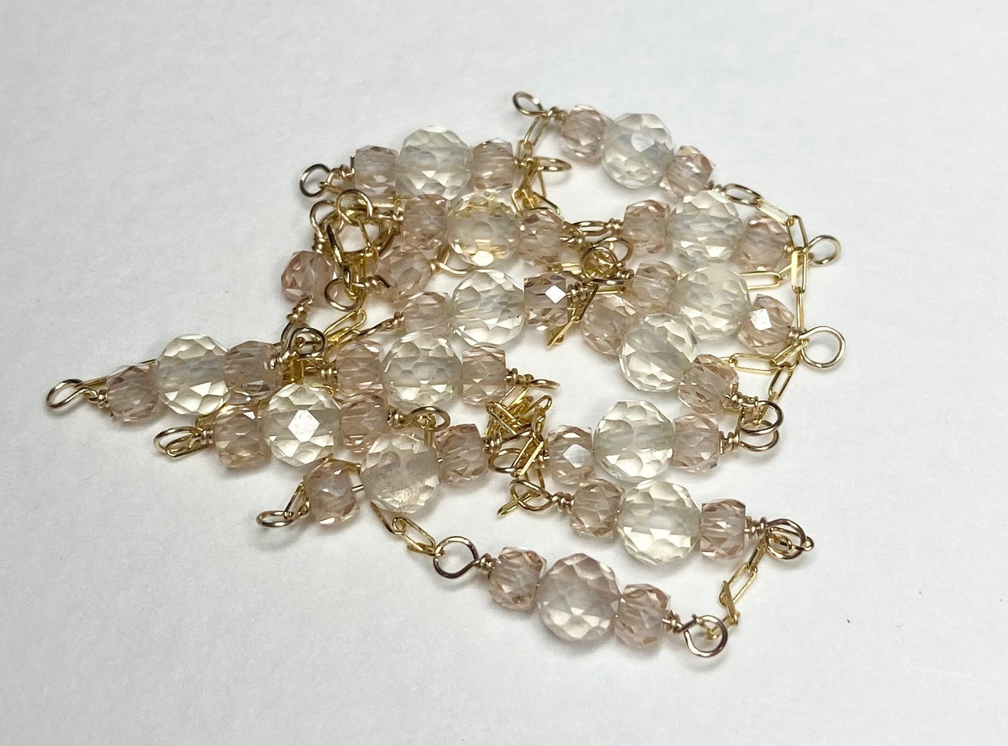 A delicate 14k yellow gold necklace with faceted Oregon sunstones and natural zircons.