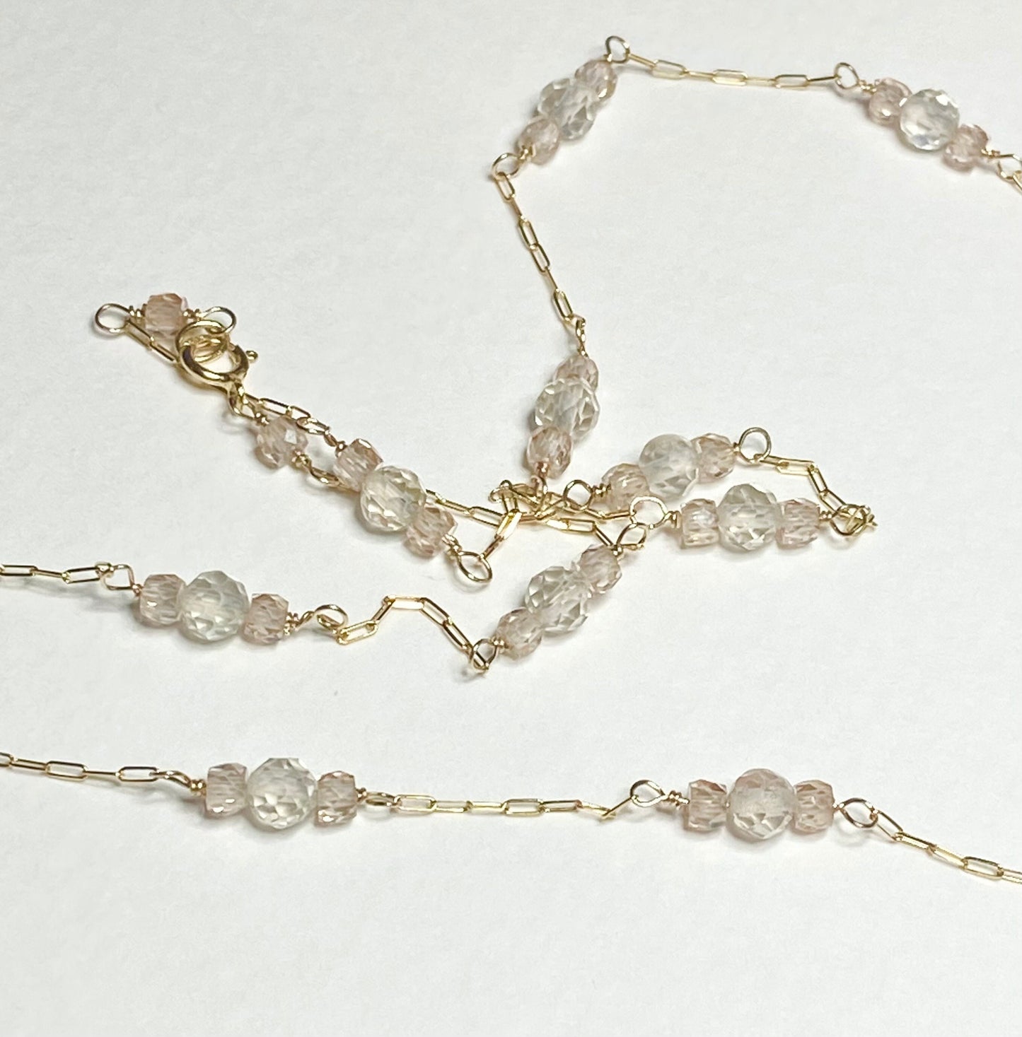 A delicate 14k yellow gold necklace with Oregon sunstone and zircon stations.