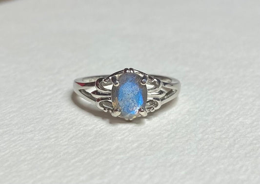 Sterling silver ring with oval blue flash labradorite in a fleur de lis setting.