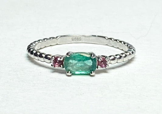 Sterling silver ring with oval emerald and two pink bixbite stones.