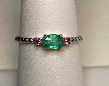Sterling silver ring with oval emerald and two pink bixbite stones.