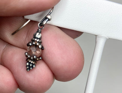 Sterling silver dangle earrings with a sunstone bead and Bali-style accents.