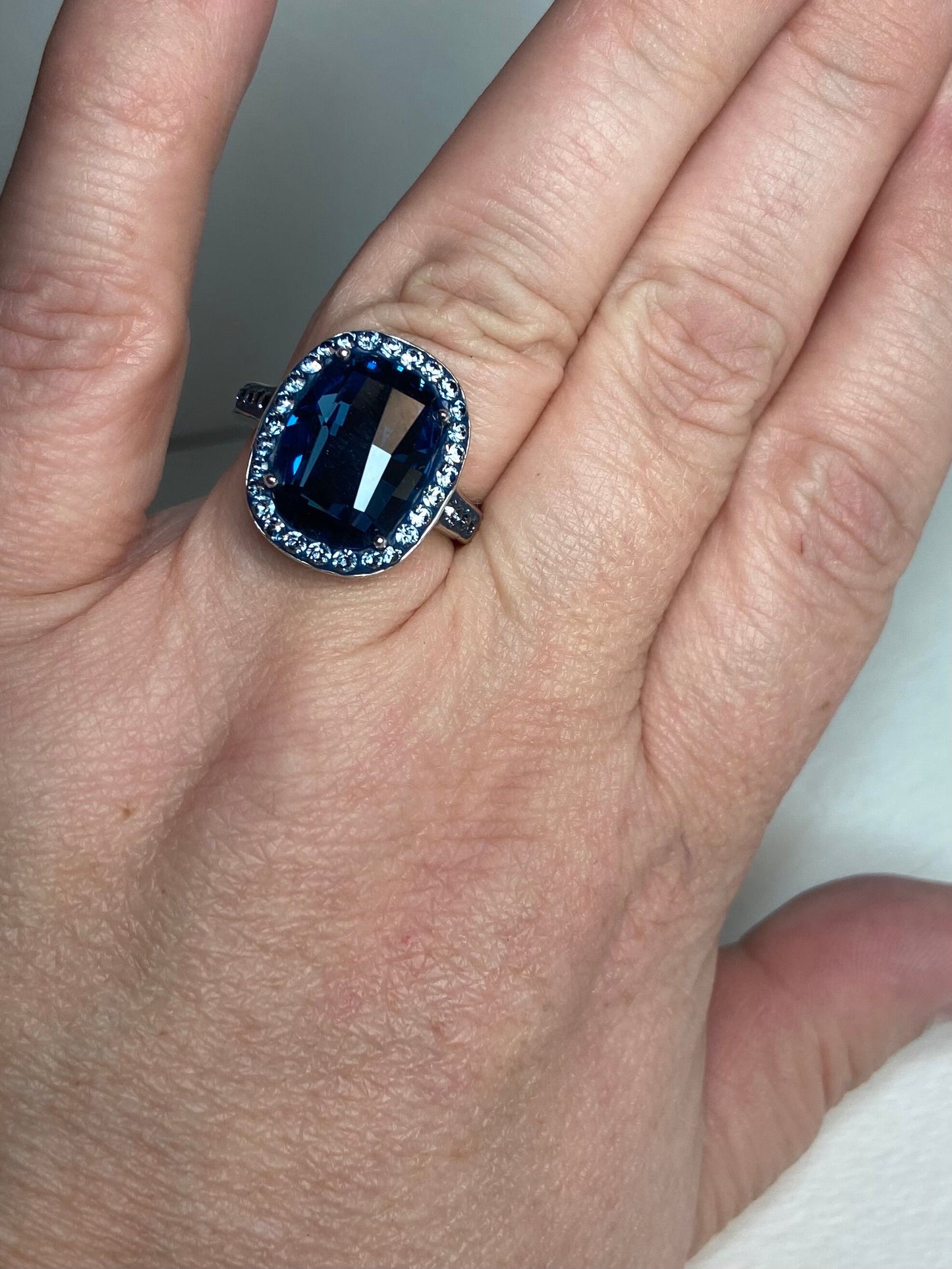 Sterling silver ring with a large Montana blue Swarovski crystal surrounded by smaller crystals.
