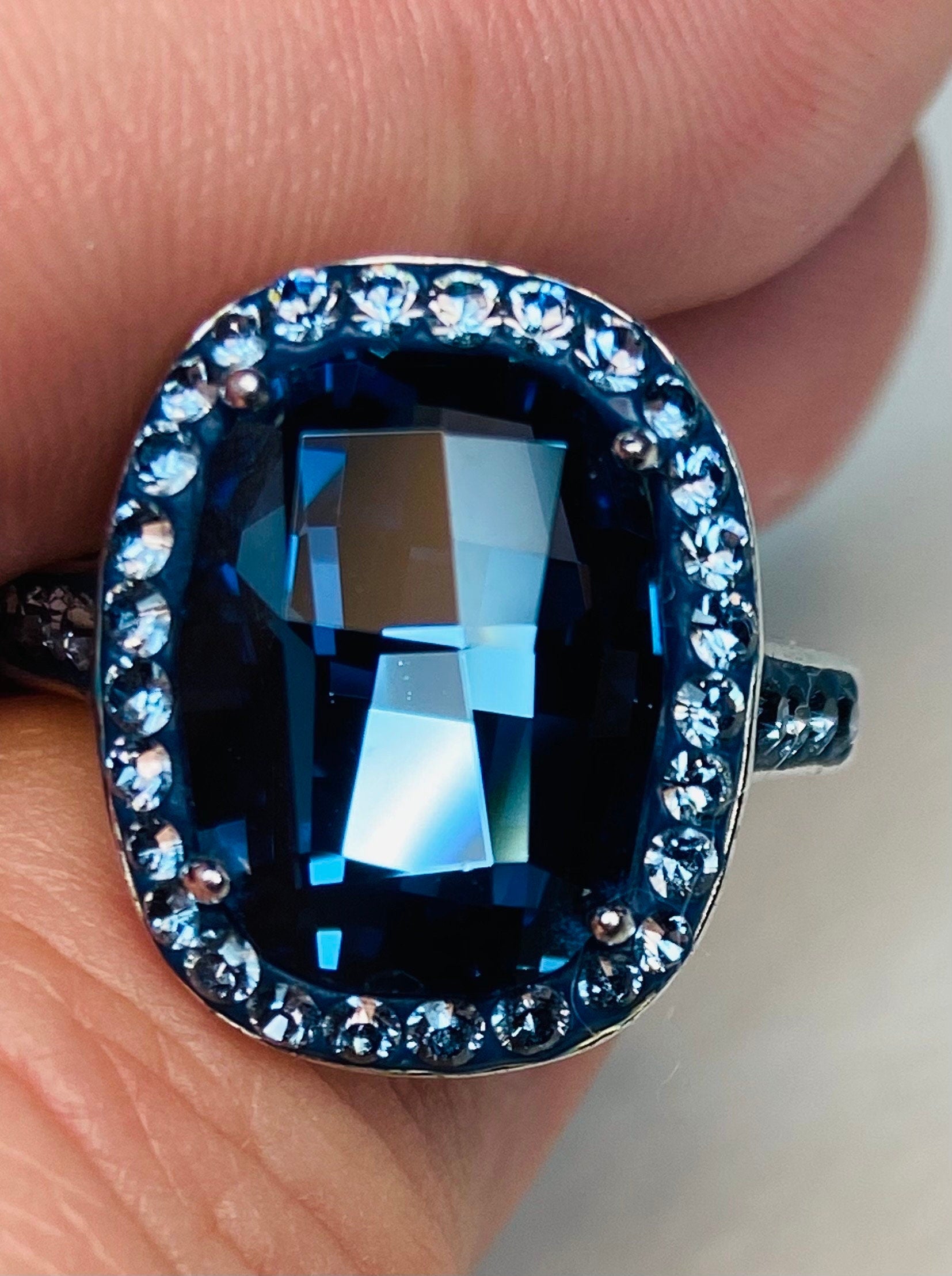Sterling silver ring with a large oval Montana blue Swarovski crystal surrounded by smaller crystals.