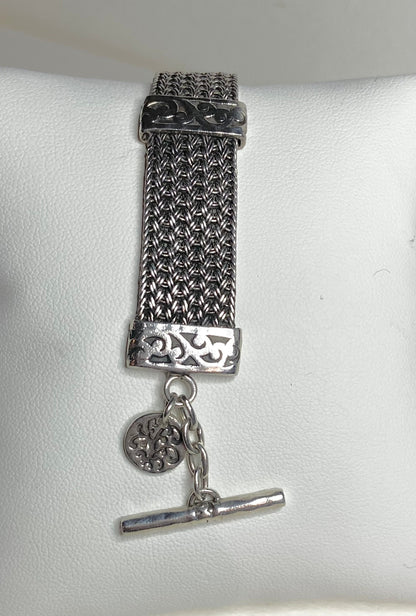Lois Hill wide woven toggle sterling silver bracelet with a decorative charm.
