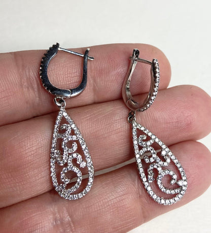 Sterling silver pave tear drop dangle earrings with lever back closure.