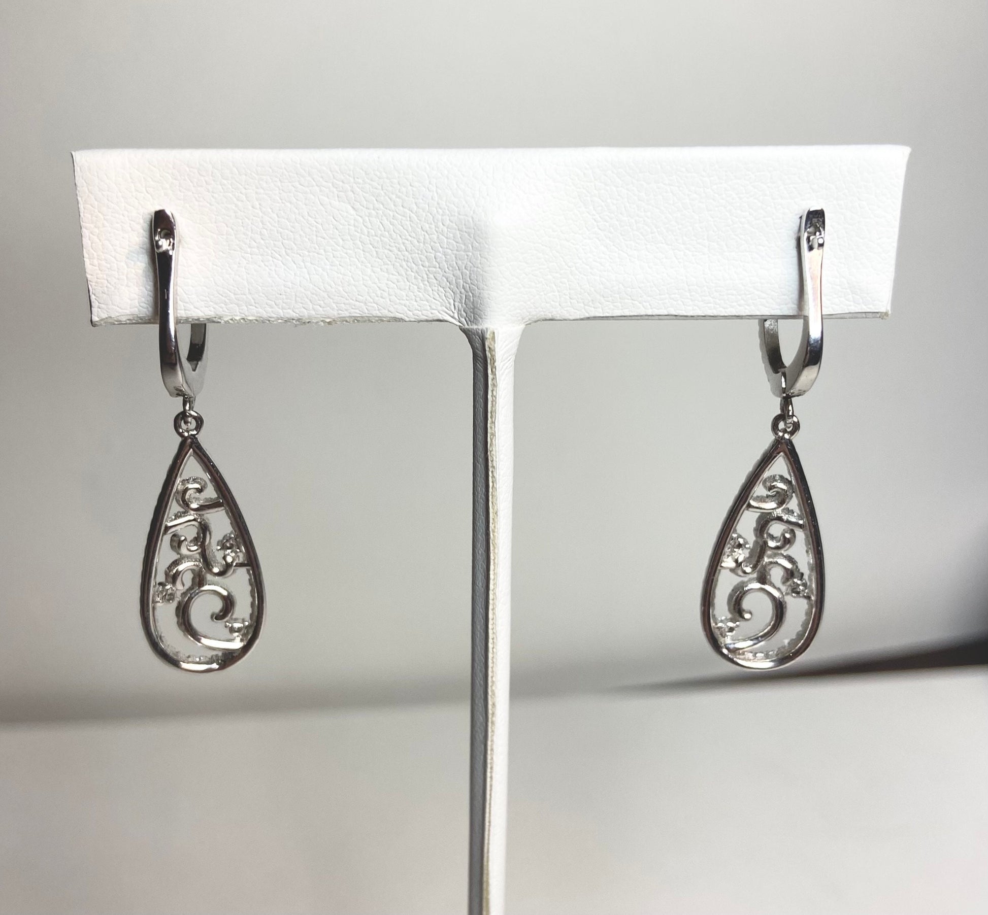 Sterling silver dangle earrings with pave cz stones in a tear shape.
