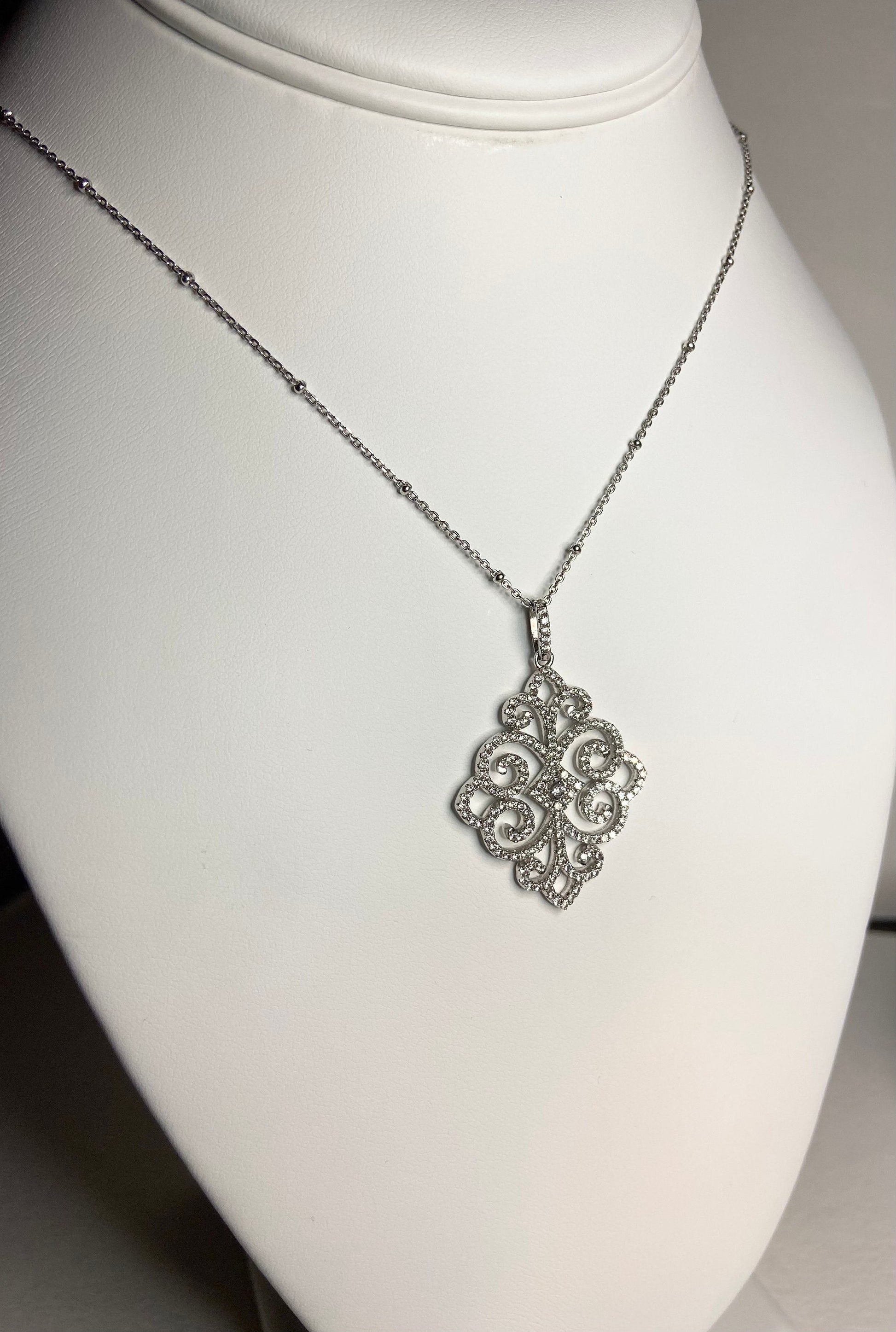 Rhodium over sterling silver pave swirl pendant necklace.