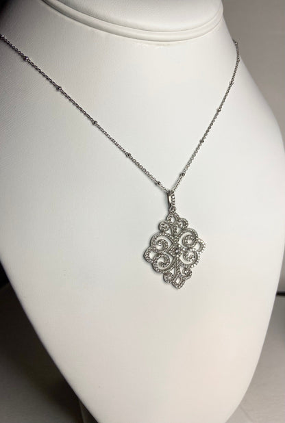 Rhodium over sterling silver pave swirl pendant necklace.