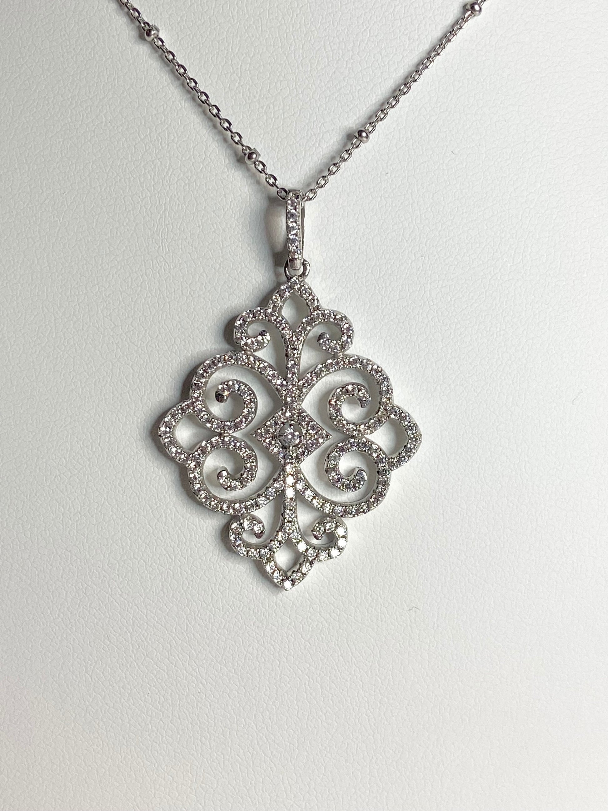 Rhodium over sterling silver pave swirl pendant necklace.