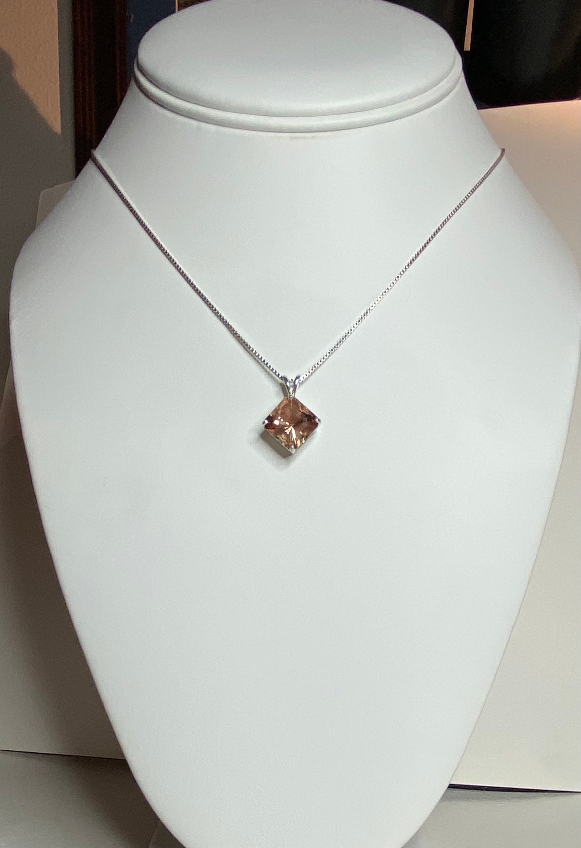 Sterling silver necklace with a large, square-cut Oregon sunstone pendant.