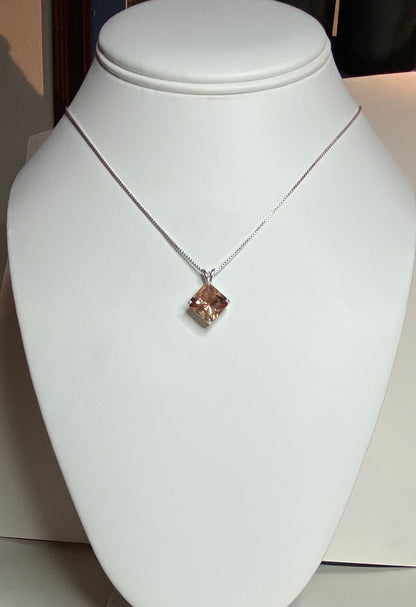 Sterling silver necklace with a large, square-cut Oregon sunstone pendant.