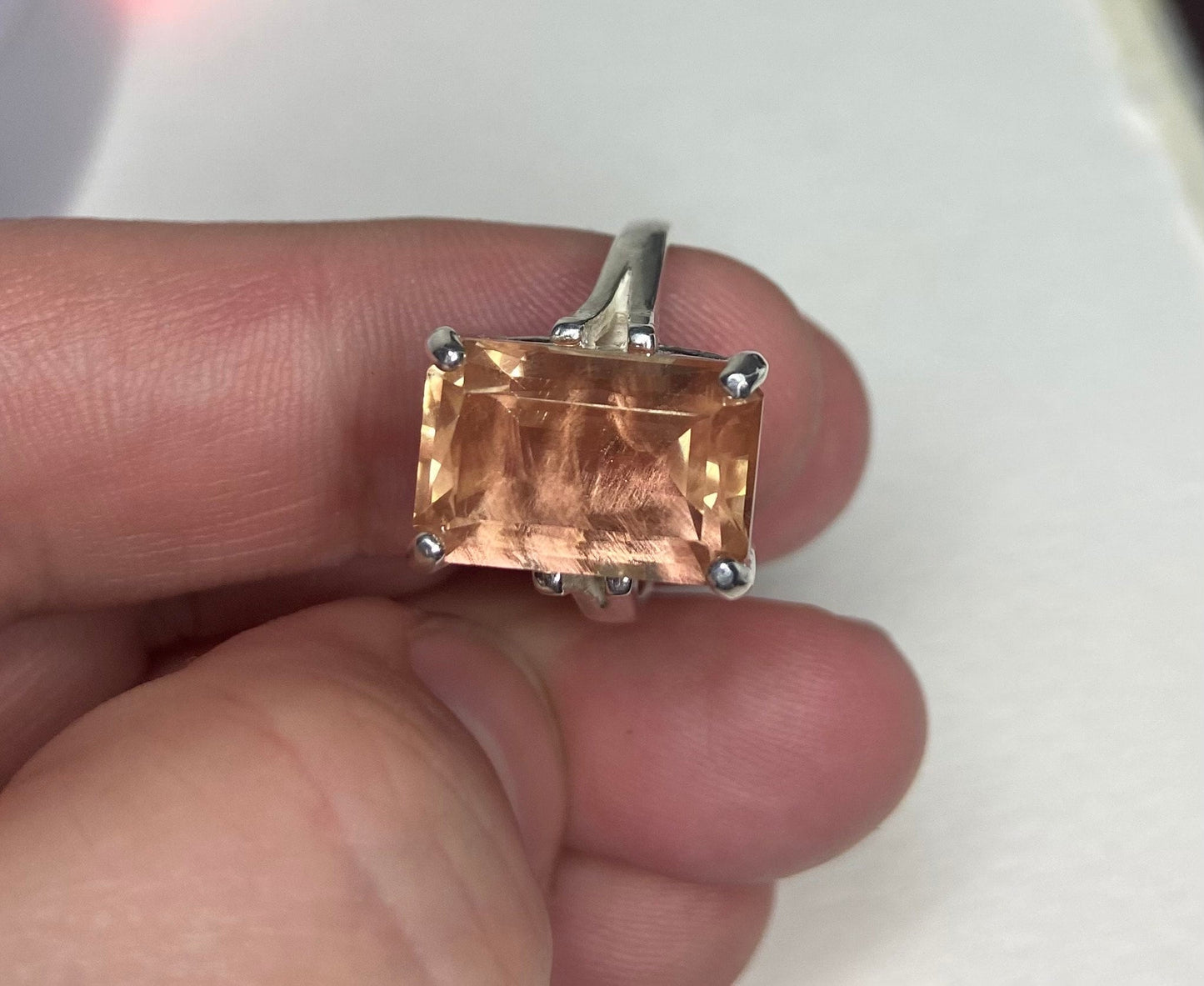 Sterling silver band ring with a large, emerald-cut Oregon sunstone.
