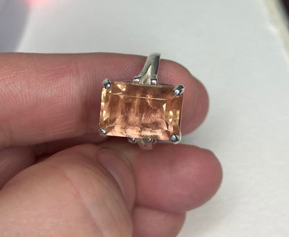 Sterling silver band ring with a large, emerald-cut Oregon sunstone.