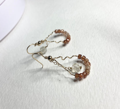 Hand-forged dangle earrings with brown zircons and a faceted Oregon sunstone.