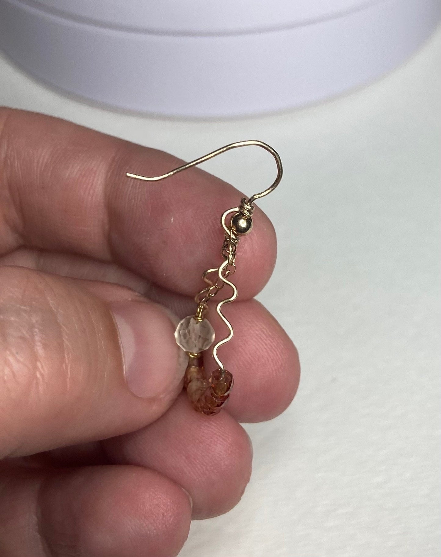 Hand forged dangle earrings with natural zircon and Oregon sunstone.