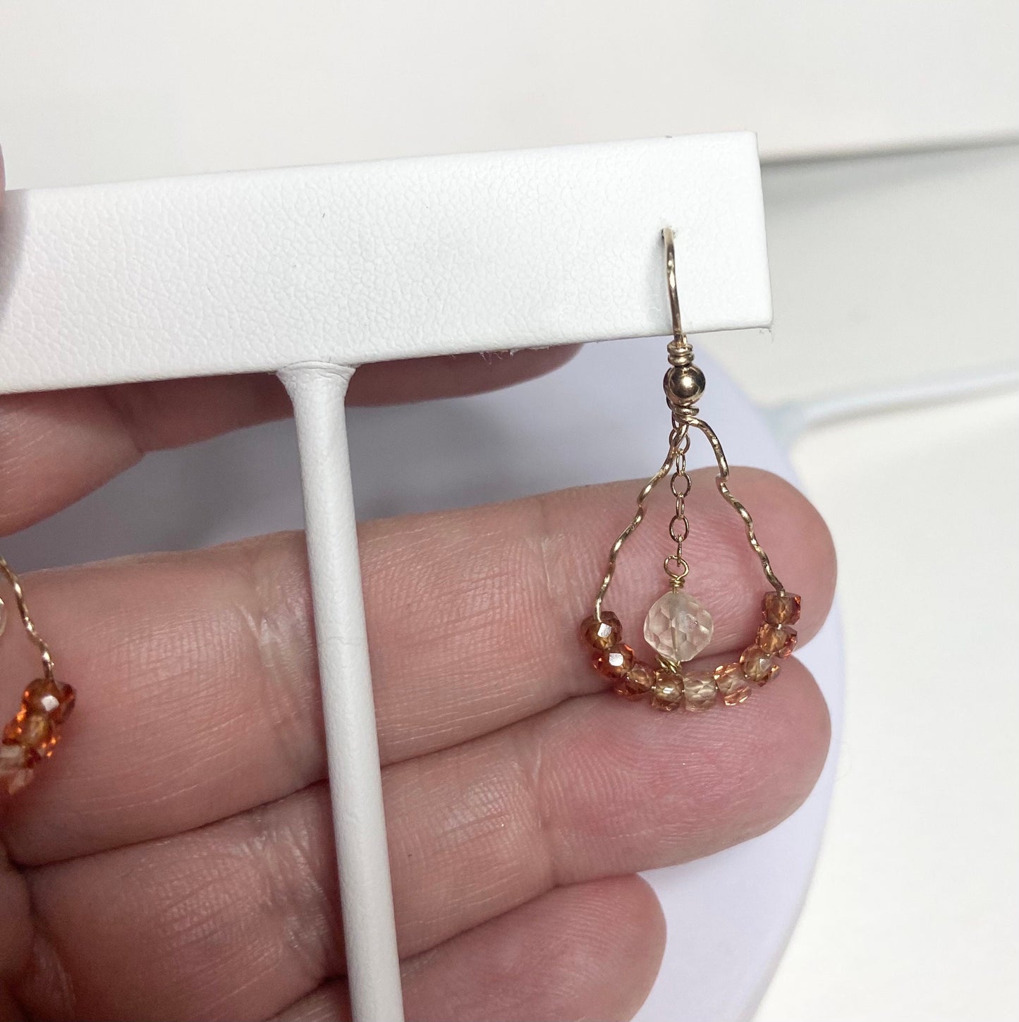 Hand-forged dangle earrings with natural zircons and an Oregon sunstone.