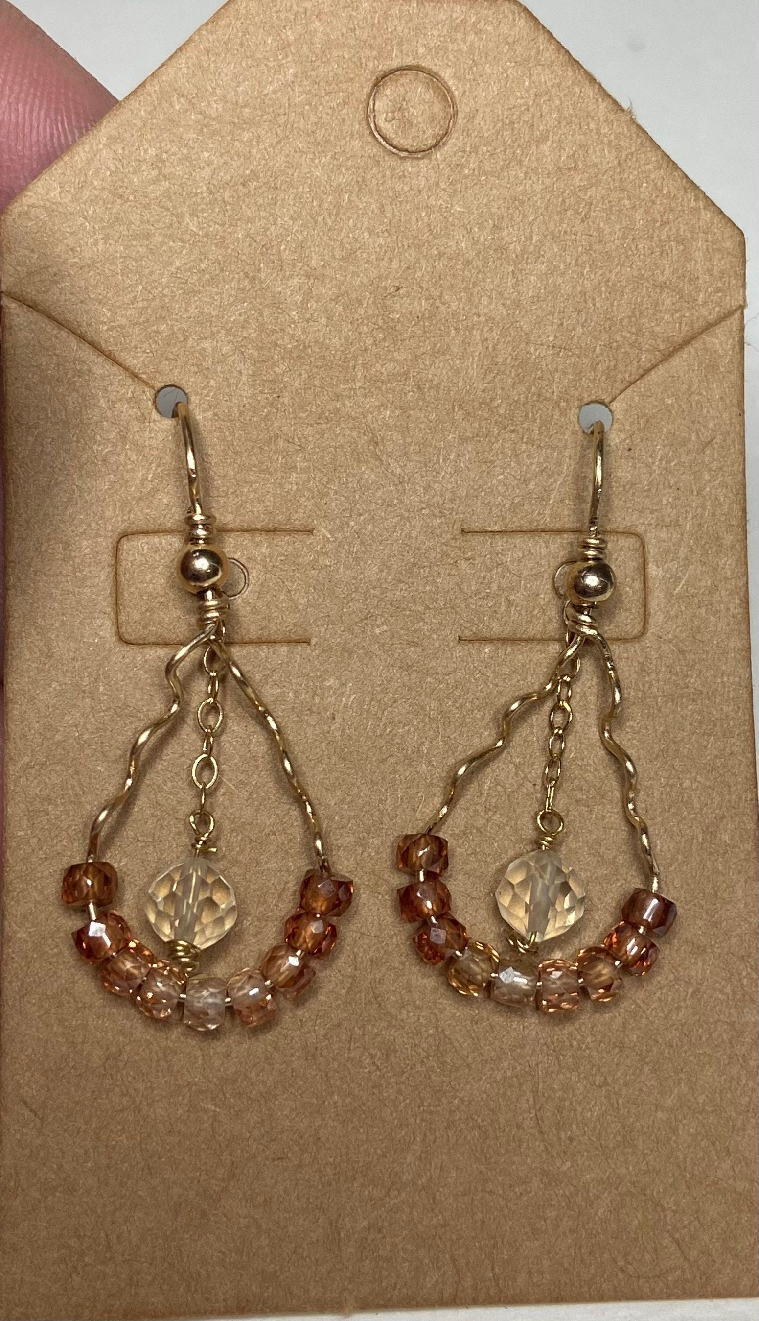 Hand forged dangle earrings with ombre zircons and a central Oregon sunstone.