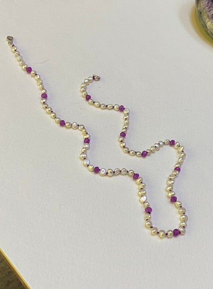 Freshwater oval keshi pearls with purple jade accents on a sterling silver clasp necklace.