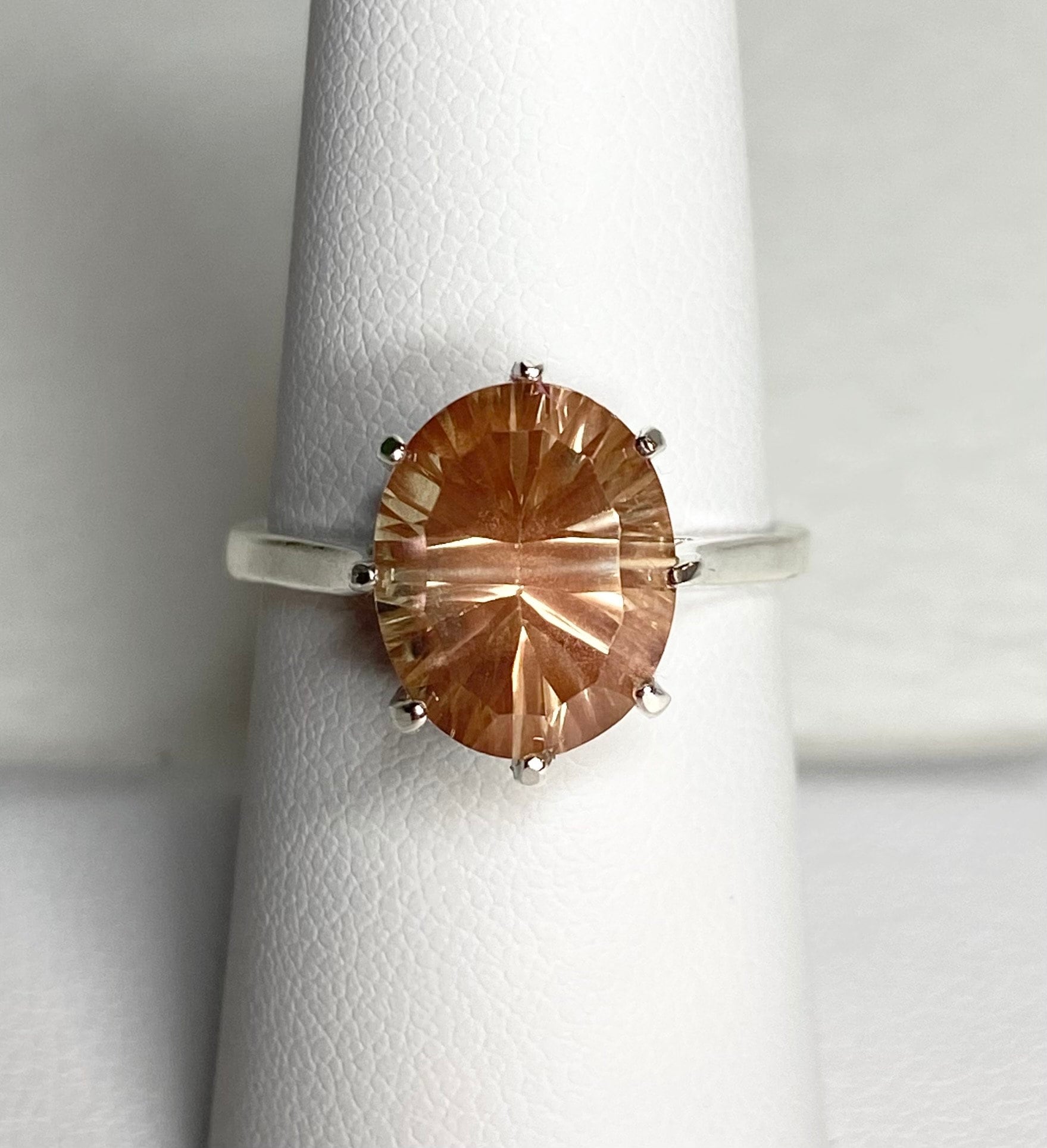 Sterling silver ring with an oval, peach-colored Oregon sunstone.