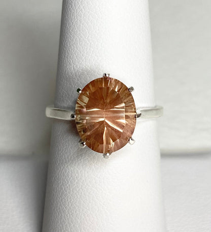 Sterling silver ring with an oval, peach-colored Oregon sunstone.